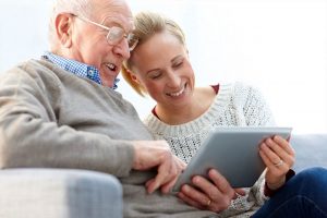 Senior Man and Daughter Using a Tablet Together