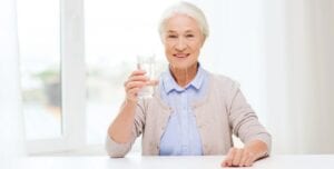 Senior Woman Holding a Glass of Water